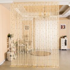 a living room with sheer curtains on the wall