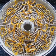 the inside of a white basket with yellow peels in it on a blue surface