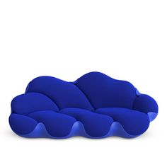 a blue cloud shaped couch sitting on top of a white floor next to a wall