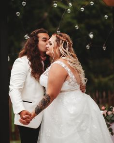 a bride and groom kissing in front of bubbles