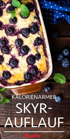 a close up of a casserole dish with blueberries on it and the words skyr - auflauf