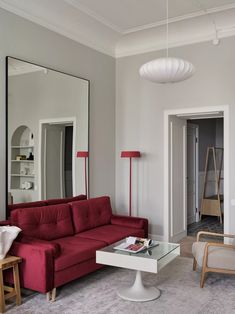 a living room filled with furniture and a large mirror