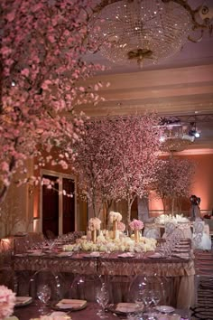 an image of a wedding reception with cherry blossom tree centerpieces