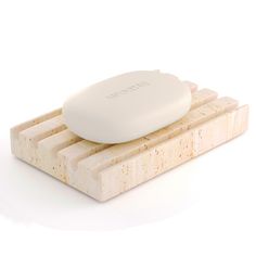 a soap dish sitting on top of a wooden block