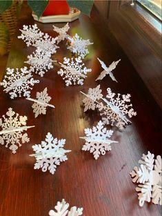 snowflakes are scattered on a wooden table