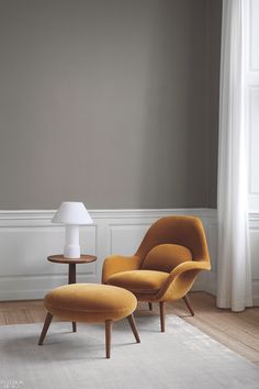 an orange chair and ottoman in a room