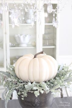 a white pumpkin sitting on top of a table