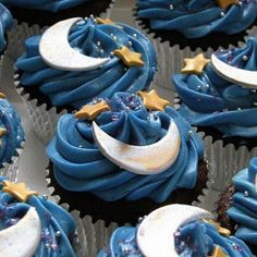 cupcakes decorated with blue frosting and gold stars, moon and crescent decorations