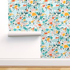 the wall paper is designed to look like paint splattered with different colors and shapes