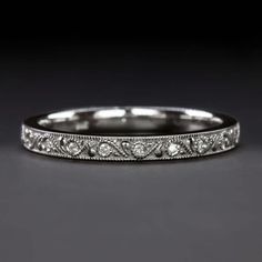 an antique style wedding band with diamonds