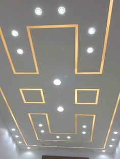 an empty room with some lights on the ceiling