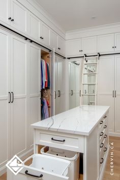 A white walk-in closet with a rolling ladder and Closet With Middle Island, Walk In Closet Seating Ideas, Master Closet Center Island, Closet Pull Out, Closet With Ladder Small Spaces, Small Closet With Island, Walk In Closet Ideas Farmhouse, Master Closet With Island And Vanity, Narrow Closet Island