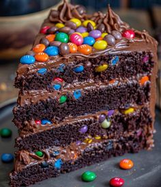 a slice of chocolate cake with m and m candies on top