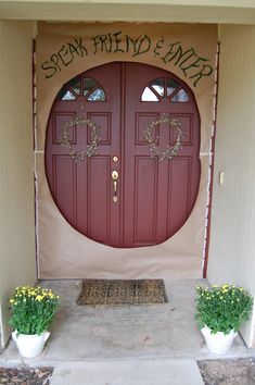 two potted plants sit in front of a red door with the words speak hello and erp written on it