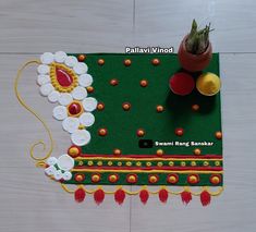 this is an image of a decorated mat with flowers and potted plant on it