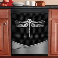 a dragonfly is sitting on the back of a dishwasher in a kitchen