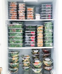 an open refrigerator filled with lots of salads and plastic containers full of food sitting on the shelves