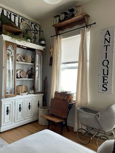 a living room filled with furniture and lots of clutter on top of the shelves