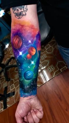 a person with a colorful tattoo on their arm holding the hand of another person in space