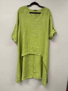 Elevate your wardrobe with our Italian linen Hi-low top. Indulge in luxury with the graceful Hi-Low effect, perfect for any occasion. The soft, comfortable fabric and versatile rolled short sleeve add a unique touch. A must-have exclusive piece for the sophisticated and tasteful. Solid Color Linen T-shirt For Spring, Green Short Sleeve Tunic For Vacation, Lagenlook Solid Color Summer Tops, Green Half Sleeve Tops For The Beach, Green Half-sleeve Top For Vacation, Green Half Sleeve Tops For Vacation, Green Half Sleeve Top For Vacation, Green Short Sleeve T-shirt For Layering, Summer Linen T-shirt For Layering