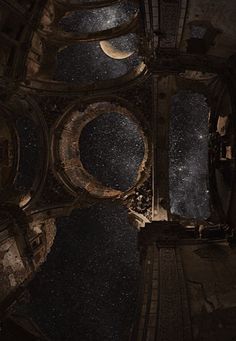 the view from above looking down at an old building with a moon and stars in the sky