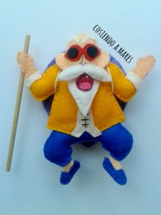 an odd looking stuffed animal with a stick in it's mouth and wearing glasses