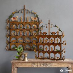 a wooden table topped with figurines next to a wall mounted shelf filled with toys