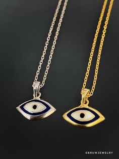 The Dainty Evil Eye Necklace is perfect for you if you're looking for something simple to wear every day. This beautiful necklace features a small evil eye charm on a sterling silver chain and will brighten your day with its protective energy and bring you good luck. This necklace comes in a silver and a 18k gold plated variant. The Dainty Evil Eye Necklace also has a matching bracelet and earrings. The Evil Eye bead is a prominent symbol in Turkish and many other cultures, and is highly protect Symbolic Necklaces With Silver Chain And Round Pendant, Symbolic Necklace With Silver Chain And Round Pendant, Symbolic Necklaces With Round Silver Pendant, Silver Chain Pendant Amulet Necklace, Symbolic Silver Chain Necklace With Round Pendant, Sterling Silver Symbolic Pendant Necklace, Sterling Silver Pendant Chain Necklace With Charms, Symbolic Sterling Silver Pendant Necklace, White Sterling Silver Amulet Necklace