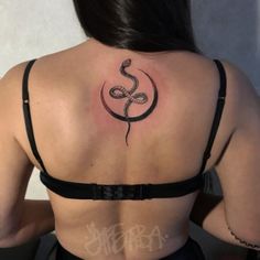 a woman with a snake tattoo on her back