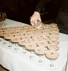 a table topped with lots of wine glasses filled with champagne and covered in buttons,