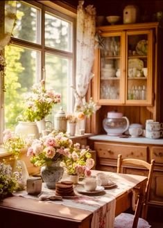 a dining room table with flowers in vases on it