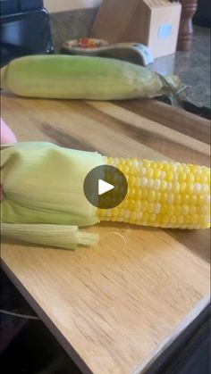 corn on the cob sitting on top of a cutting board