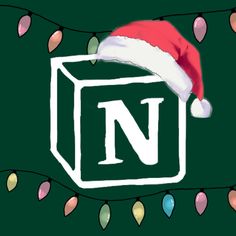 a christmas hat on top of a box with lights around it and the letter n