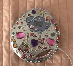 an electronic device with lots of stickers on it's face and back side