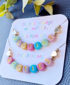 Bright and beautiful Besties, BFFS, Squad, or Tribe necklace set with colorful letters and a gold heart & round gold beads at each end.  You will receive 2 necklaces with this set. There are few things more special than a best friend, and this necklace set makes a fun and wonderful gift for you and your bestie! It's also perfect to show everyone who's on your squad!   The beads are gorgeous jewel tones with gold lettering, sure to be eye catching.  You will receive two necklaces with this set, on a necklace card that reads:  Besties always we will be, one for you, one for me. You will also receive two cute suede pouches for storage, one for each of you!  You can choose whether you'd like the colors in the necklaces to match exactly or choose mixed colors for each necklace.  Bead colors wil Bestie Necklace, Tribe Necklace, 2 Besties, Bff Necklace, White Beads Bracelet, Two Necklaces, Girl Necklace, Bff Necklaces, Bff Gift