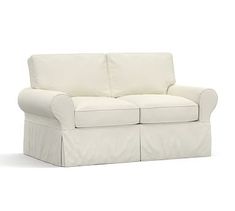 a white couch sitting on top of a white floor