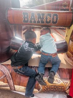 Two little cowboys. Mechanical bull. Little boys. Little cowboys. Boots. Country. Toro mechanico. Little boys. Two boys. Little boys. Career