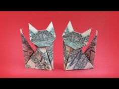 two origami cats made out of money on a red background, one is folded up to look like the other