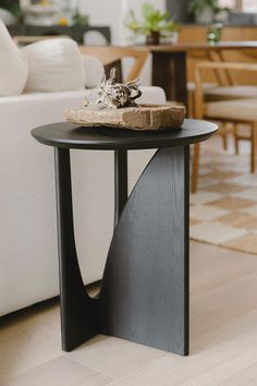 a table with a piece of wood sitting on top of it next to a couch