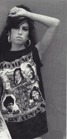 a black and white photo of a woman holding a skateboard with her hands on her head