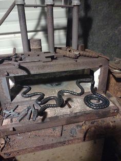 an old metal box that has some kind of snake on it