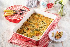 a casserole dish with broccoli and cheese in it on a table