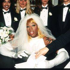 a group of women dressed in black and white posing for a photo on their wedding day