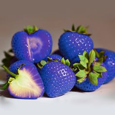 some strawberries are sitting on a white surface