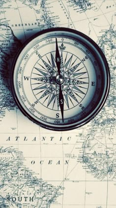 a compass sitting on top of a map