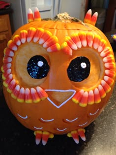 a carved pumpkin with an owl face on it