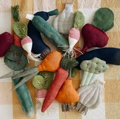 an arrangement of different colored vegetables on a checkered table cloth