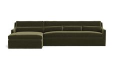 a large green couch sitting on top of a white floor next to a footstool