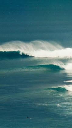 two surfers are riding the waves in the ocean