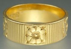 A gorgeous vintage Mid Century 22K gold engraved dog rose 6.4mm wedding band ring, signed by the Albion Craft Company and dated to 1960. We understand this very eye catching unique ring is one of the first designs from the celebrated London jewelers Albion Craft Company who operated from 1960 to 1995 in Benjamin Street. The finely made ring has been created in rich glowing solid 22K yellow gold and has five beautiful highly detailed dog roses carved around the band with lovely etched lines separating them designed to catch and reflect the light from every direction. The ring has English hallmarks with maker 'Albion ACCo' for the Albion Craft Company, the crown for gold, '22', the London leopard's head and date letter 'e' for 1960. The ring tests for 22K gold. The ring is approximately a si Vintage Engraved Yellow Gold Flower Ring, Art Nouveau Engraved Yellow Gold Jewelry, Art Nouveau Engraved Yellow Gold Ring, Engraved Yellow Gold Art Nouveau Jewelry, Floral Wedding Band, 1960s Fine Gold Jewelry, Floral Wedding Bands, Dog Rose, Antique Jewelry Rings